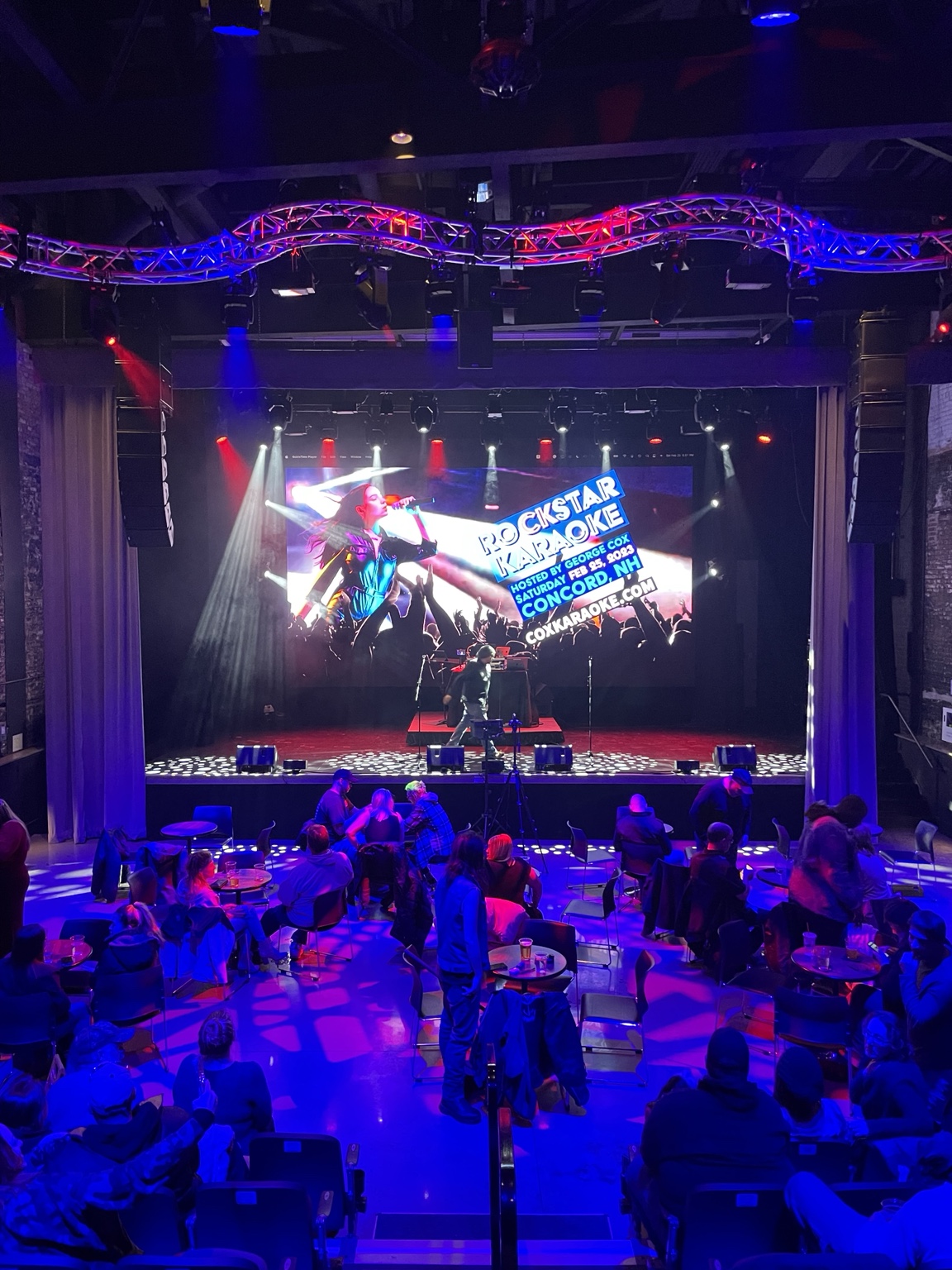 Rockstar Karaoke hosted by George Cox at Bank of NH Stage, with the illuminated theatre stage and audience